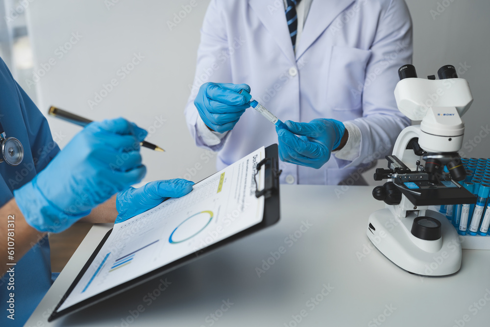 Scientist working with a microscope Laboratory team doing medical research Scientific test tubes in the laboratory for analyzing data in the lab Biological concept, insurance. Scientist working with a microscope Laboratory team doing medical research Scientific test tubes in the laboratory for analyzing data in the lab Biological concept, insurance.