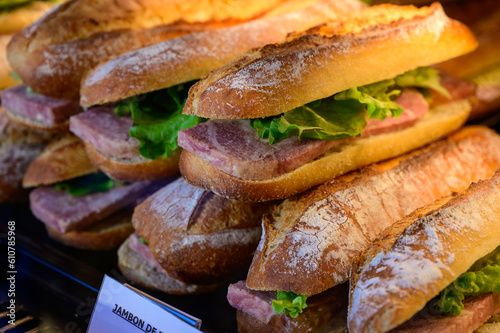 Fresh made organic sandwiches with baquette buns, bacon and salad, english translation is bacon.