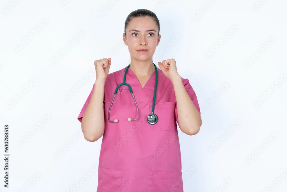 young caucasian doctor woman wearing pink uniform over white background champion having success being glad to achieve his goals. Victory and triumph concept. young caucasian doctor woman wearing pink uniform over white background champion having success being glad to achieve his goals. Victory and triumph concept.
