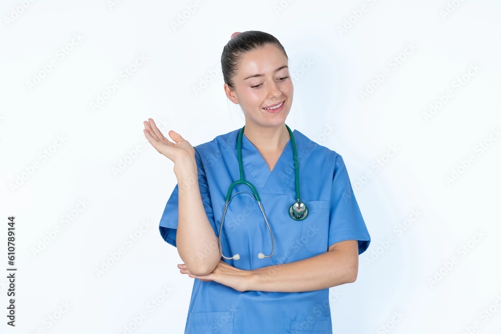 Overjoyed successful young caucasian doctor woman wearing medical uniform over white background raises palm and closes eyes in joy being entertained by friends Overjoyed successful young caucasian doctor woman wearing medical uniform over white background raises palm and closes eyes in joy being entertained by friends