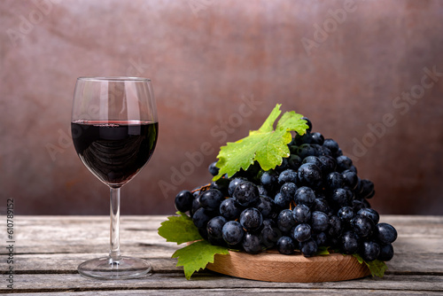 Red wine and grapes on wooden background