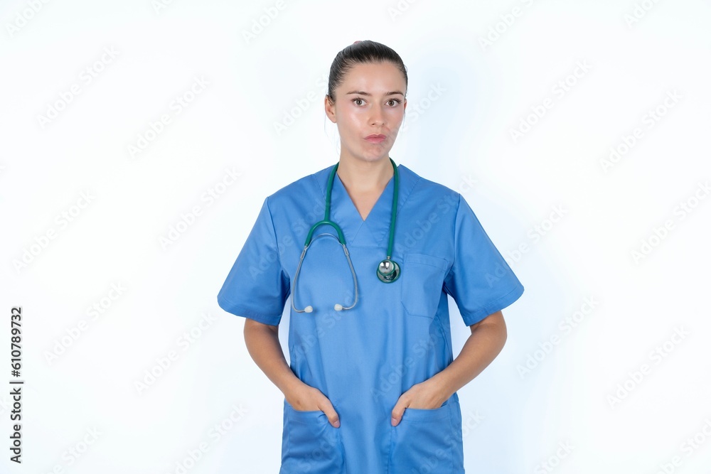 Portrait of lovely funny young caucasian doctor woman wearing medical uniform over white background sending air kiss Portrait of lovely funny young caucasian doctor woman wearing medical uniform over white background sending air kiss