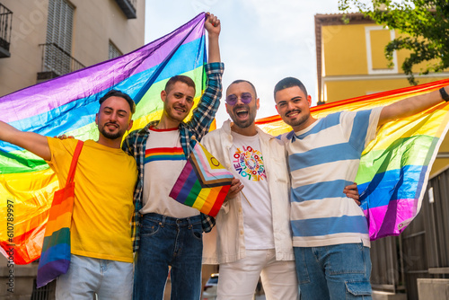 Lifestyle of homosexual friends hugging at gay pride party in the city, diversity of young people, demonstration with rainbow flags, lgbt concept