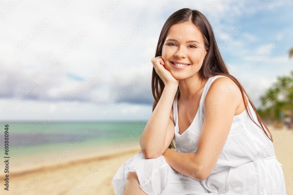 Portrait of smiling young woman at the beach Portrait of smiling young woman at the beach