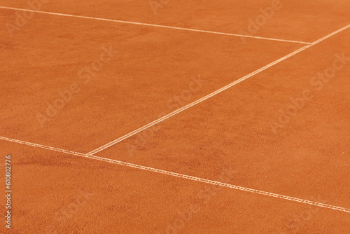 tennis court made of red clay soil with markings for game or competition. sports and recreation, professional performance champions in lawn tennis with rackets and balls. training of athletes outdoor © MyJuly
