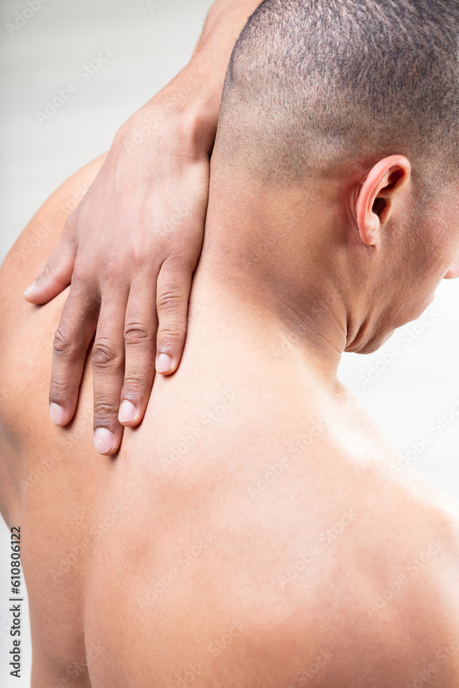 Fit man raises arm, potential muscle tension Fit man raises arm, potential muscle tension