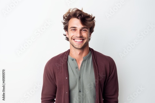 Portrait of a handsome young man smiling on a white background.