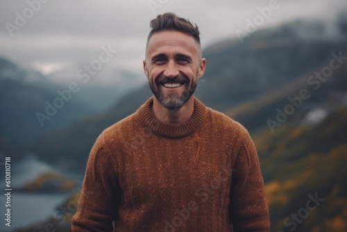 Medium shot portrait photography of a grinning man in his 30s that is wearing a cozy sweater against a bird's-eye view or aerial landscape background . Generative AI