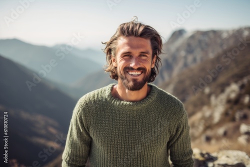Medium shot portrait photography of a grinning man in his 30s that is wearing a cozy sweater against a scenic mountain hike with breathtaking views background . Generative AI