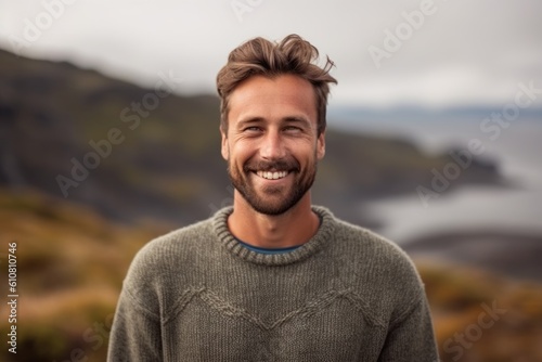 Portrait of handsome man smiling at camera on a foggy day