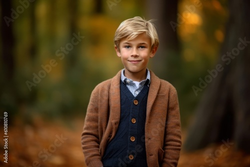 Portrait of a cute young boy in the autumn forest. Happy childhood.