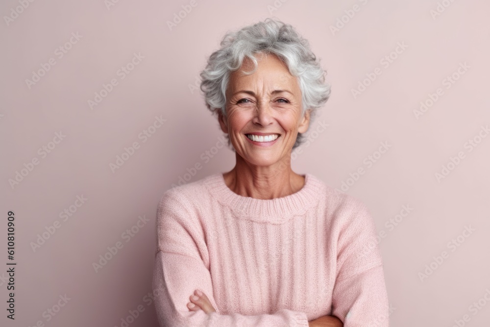 Portrait of happy senior woman with grey hair posing on pink background Portrait of happy senior woman with grey hair posing on pink background