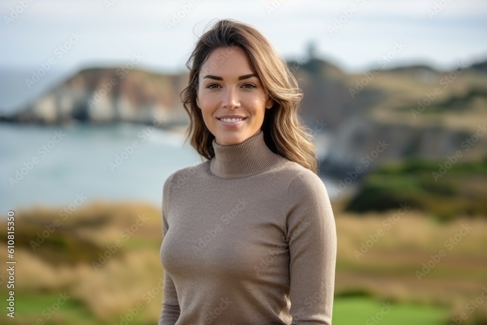Portrait of a beautiful young woman smiling at camera on the beach Portrait of a beautiful young woman smiling at camera on the beach