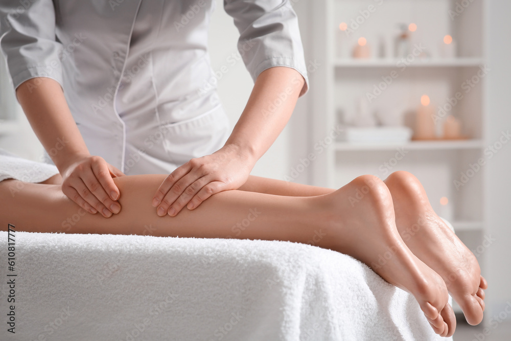Woman receiving leg massage in spa salon, closeup Woman receiving leg massage in spa salon, closeup