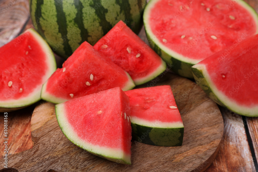Pieces of juicy ripe watermelons on wooden table, closeup Pieces of juicy ripe watermelons on wooden table, closeup