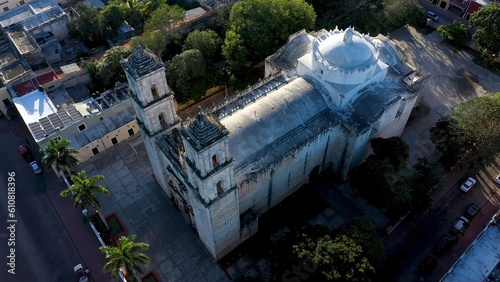 Aerial closeup with sun behind of the Cathedral de San Gervasio just after sunrise in Valladolid, Yucatan, Mexico. photo