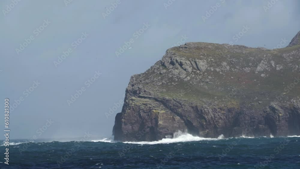 Deep Blue ocean crashing against rocky cliffs of Ireland Deep Blue ocean crashing against rocky cliffs of Ireland