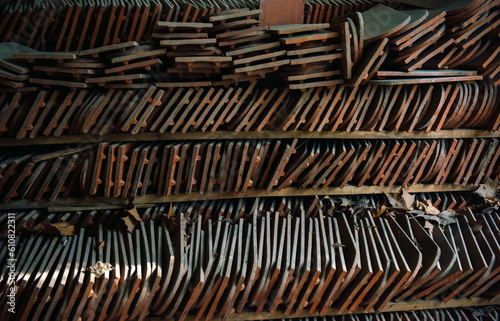 Rows of clay ceramic elements, a background of old tiles prepared for repair and restoration