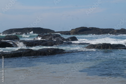 Waves breaking on the beach rocks