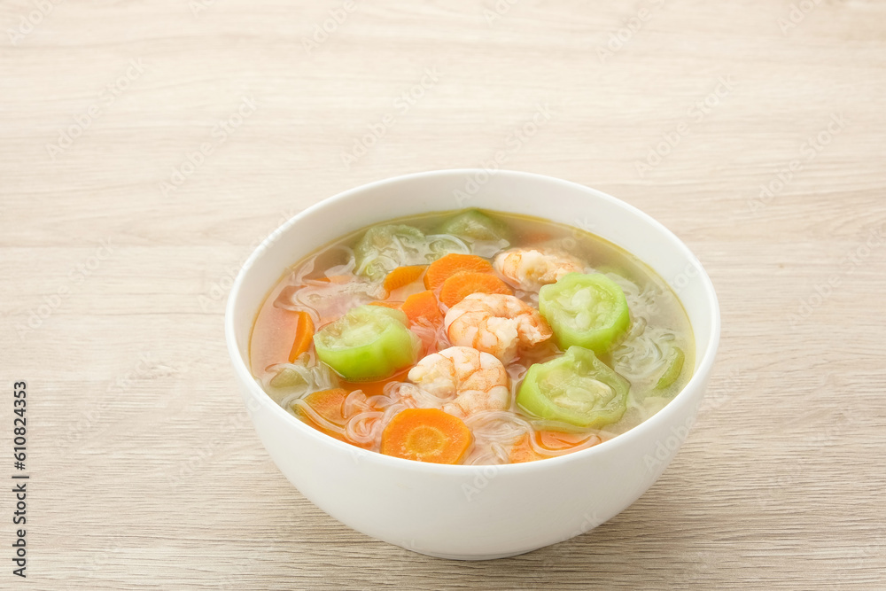 Sayur Oyong Bihun, made from luffa acutangula, carrot, shrimp and vermicelli. Served in white bowl

