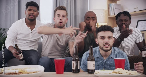 Angry, entertainment and friends watching sports together in living room with snacks and beer. Television, men and upset sport fans streaming game, match or tournament with food and alcohol at home. photo