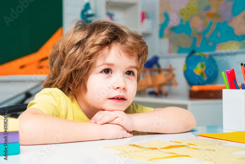 Home schooling. Little ready to study. Little children at school lesson. School dream. Daydreamer school child. Dreams and imagination. Dreamy school kid face. photo