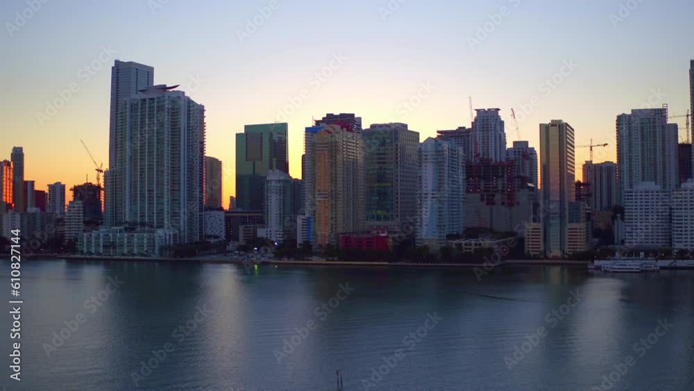 Aerial Shot Of Sea Near Buildings In City Against Sky, Drone Ascending Forward Over Modern Structures At Sunset - Miami, Florida Aerial Shot Of Sea Near Buildings In City Against Sky, Drone Ascending Forward Over Modern Structures At Sunset - Miami, Florida