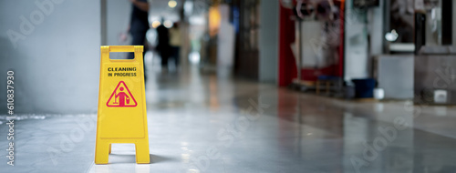 Konstfotografi Yellow plastic cone with sign showing warning of wet floor in restaurant in depa