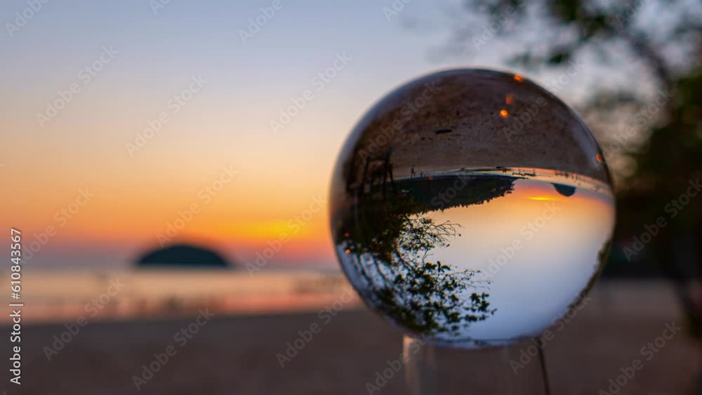 Time lapse beautiful Pu island in golden sunset inside crystal ball at Kata beach Phuket. .beautiful nature in a crystal ball by the sea..Unique and creative travel and nature idea.
