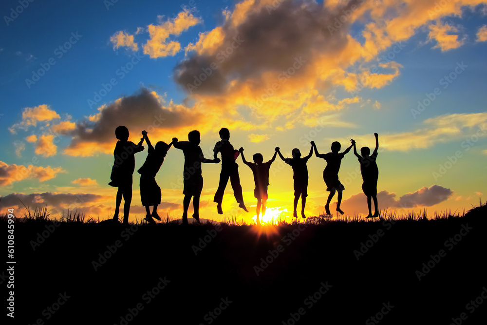 silhouette of children friendships in sunset