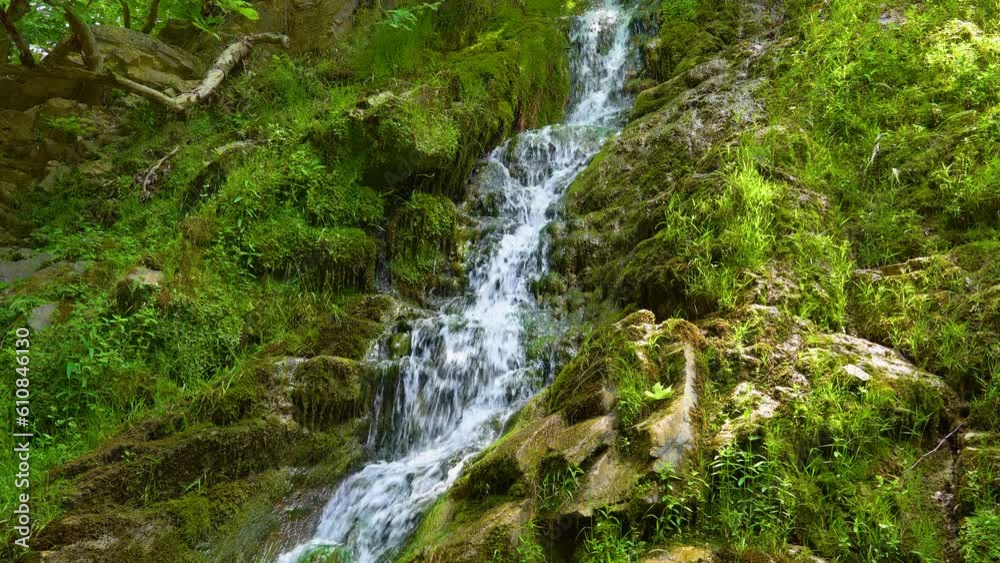 Maries Waterfall, Surrounded By Lush Green Vegetation And Rocks Covered By Moss, Sun Rays, Thassos Island, Greece Maries Waterfall, Surrounded By Lush Green Vegetation And Rocks Covered By Moss, Sun Rays, Thassos Island, Greece