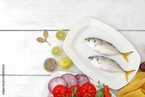 Two fish, with a yellow tail,Atule mate,fresh mediterranean fish, on a white table, background image, background photo