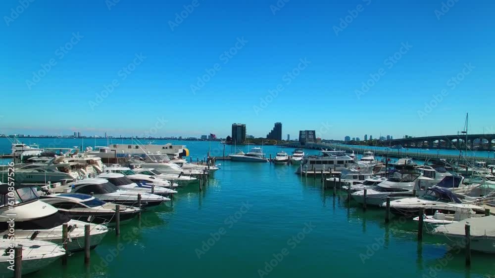 Aerial: Drone Flying Forward Over Boats Moored At Harbor On Sea Against Blue Sky During Sunny Day - Miami, Florida Aerial: Drone Flying Forward Over Boats Moored At Harbor On Sea Against Blue Sky During Sunny Day - Miami, Florida