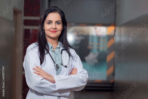 Medical concept, Indian female doctor in white coat with stethoscope standing at hospital.