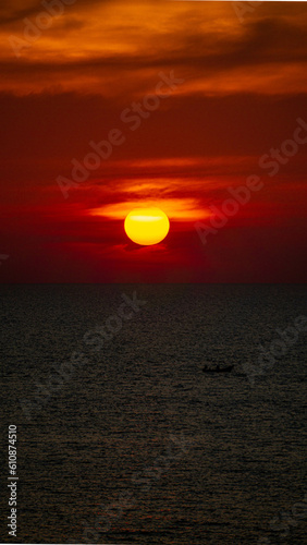 Vibrant dramatic orange sunset, dark water in Koh Lanta, Thailand