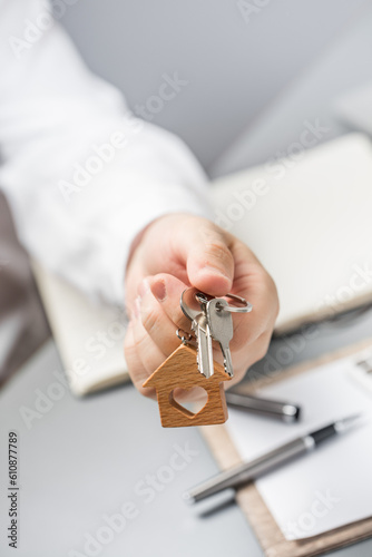 Mortgage. Apartment purchase. Keys to a new apartment. The realtor hands over the keys to the apartment to the buyer.