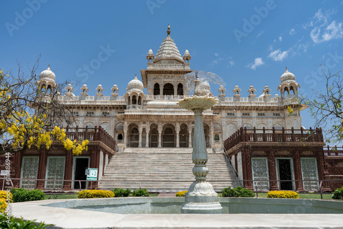 Frontal view of an indian palace made of marble with huge staircase and columns, domes and minarets