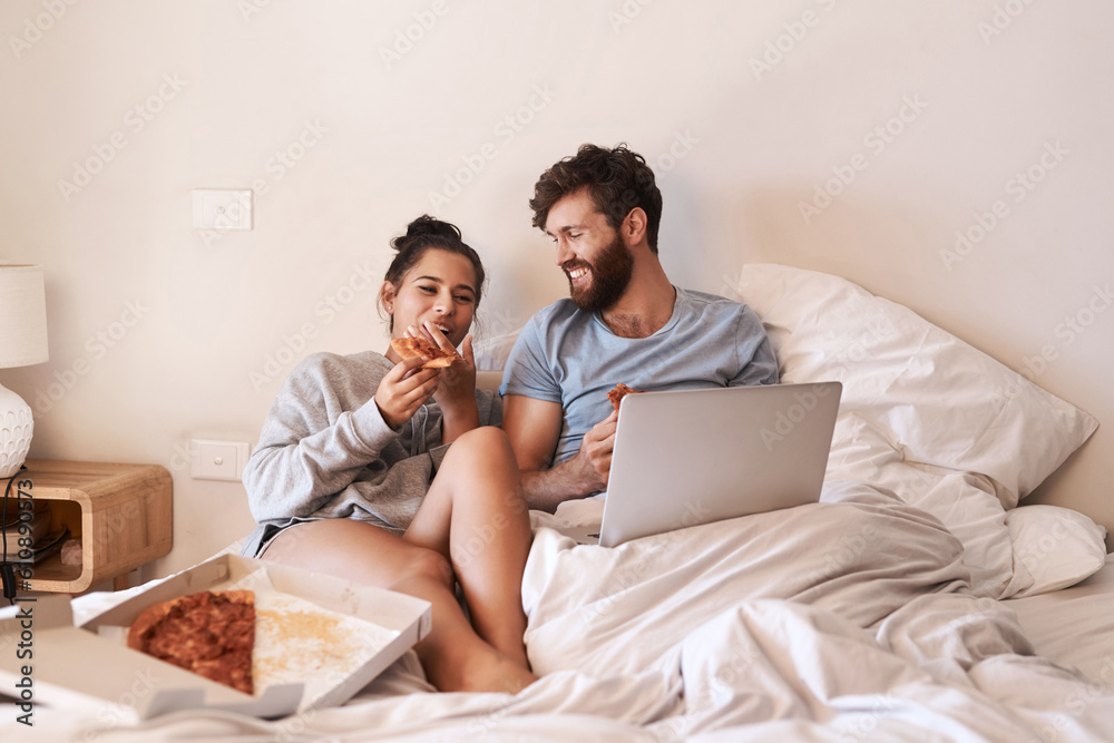 Home bedroom, pizza and happy couple relax, laugh and eating fast food, takeout meal and watch online movie. Happiness, laptop or comfortable people smile, bond and enjoy quality time together on bed