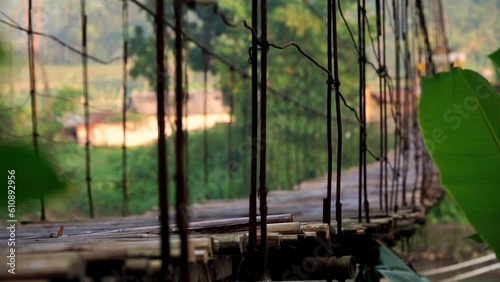 Shot of vibration on the surface of the wooden suspension bridge in Indonesia photo