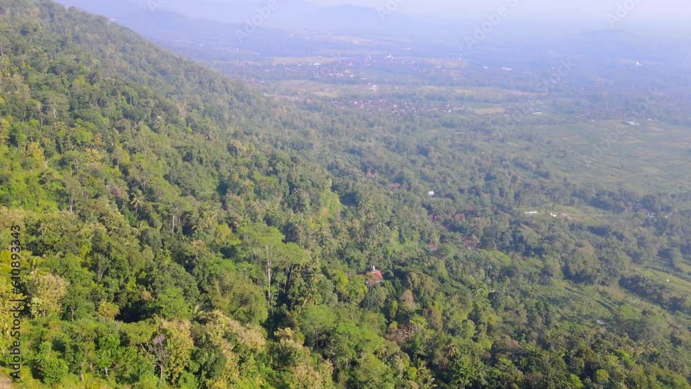 Aerial view of forest on the hill. Rain forest of Indonesia. 4K drone shot - Menoreh Hill, Indonesia Aerial view of forest on the hill. Rain forest of Indonesia. 4K drone shot - Menoreh Hill, Indonesia