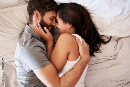 Smile, bedroom hug and happy couple laughing at funny joke, relationship humour or home comedy in Spain. Marriage happiness, love bond and top view of relax man, woman or morning people laugh in bed