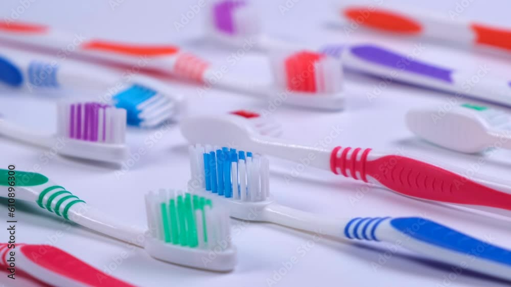 background dental toothbrushes of different colors on a white background top view background dental toothbrushes of different colors on a white background top view