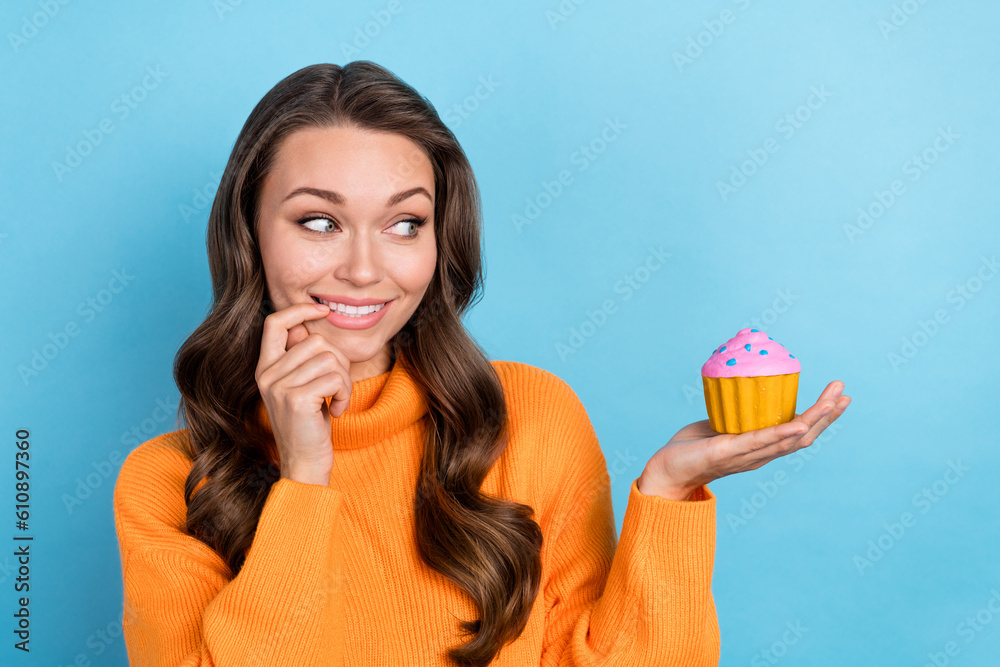 Photo of tricky cunning lady wear knitted pullover finger mouth holding hand arm small cupcake isolated blue color background Photo of tricky cunning lady wear knitted pullover finger mouth holding hand arm small cupcake isolated blue color background