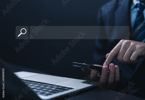 Businessman showing internet search in laptop	
