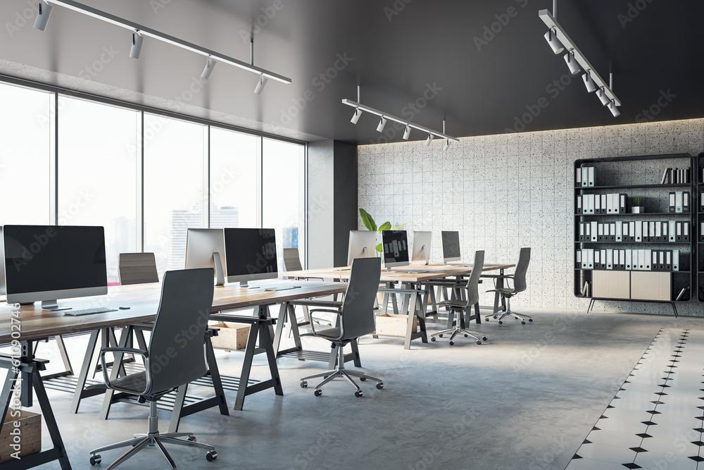Open office interior with desks, computers, a concrete floor, and black ceiling. A window provides natural light. Modern workspace design and business background. 3D Rendering
