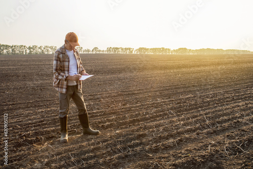 Farmer man to use check list on clip board for check quality of farm work. agriculture business concept.