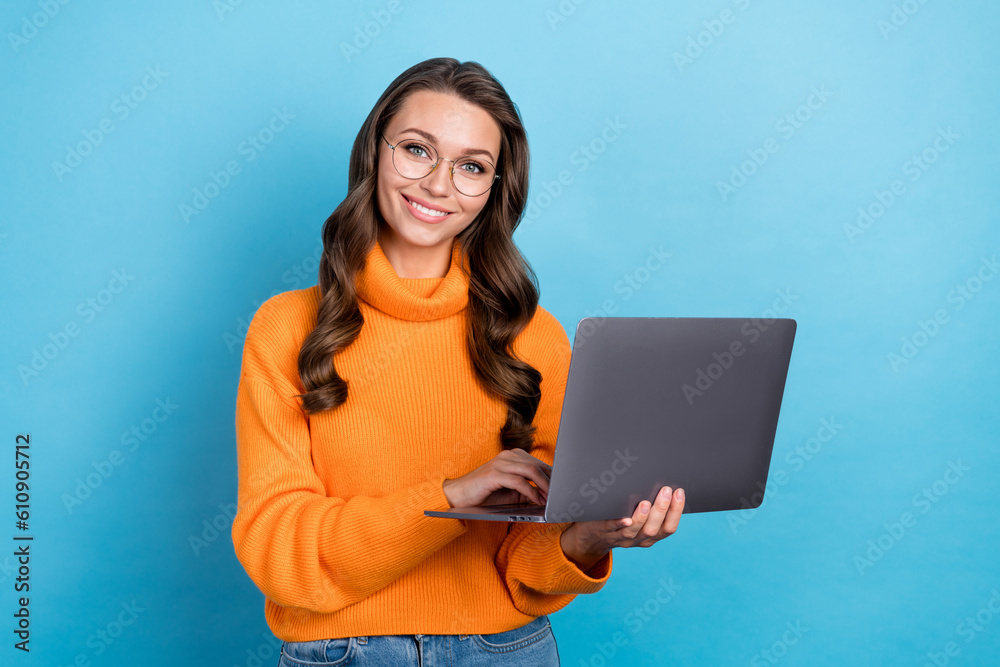 Photo of clever professional manager lady using netbook for freelance working remote isolated on blue color background Photo of clever professional manager lady using netbook for freelance working remote isolated on blue color background