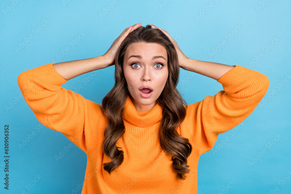 Photo of impressed funky woman dressed orange sweater arms head open mouth isolated blue color background