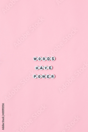 Top view of "words have power" quotes made out of beads on pink background. motivation and success concept © Yazid Nasuha