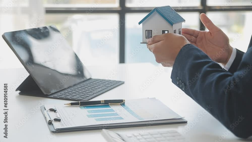Real estate broker agent presenting and consult to customer to decision making sign insurance form agreement, buy and sell home model, concerning mortgage loan offer for and house insurance